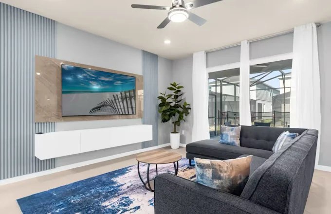 Light coastal-style media wall with a floating white console and wall-mounted television.